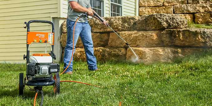 Man cleaning landscaping with a STIHL RB200 light-duty power washer